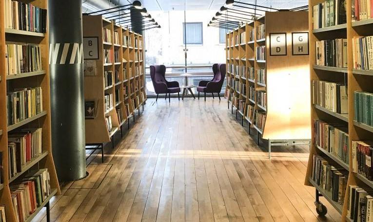 Bilde av bokhyller og en sittegruppe inne på Tønsberg bibliotek. - Klikk for stort bilde